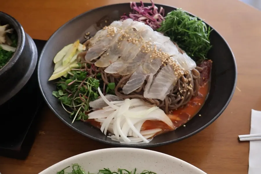 Spicy buckwheat noodles topped with raw flounder