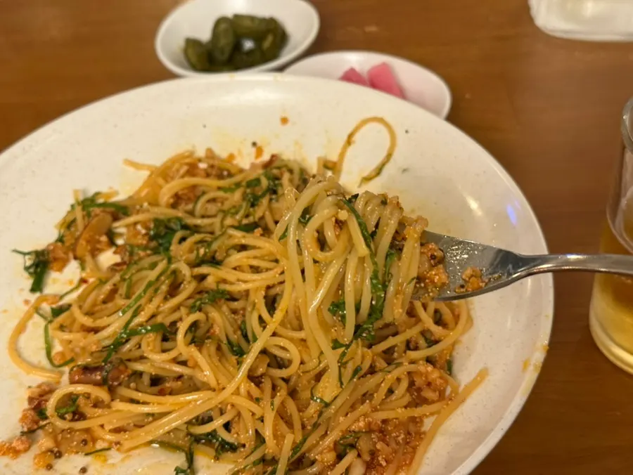 Fork lifting noodles from the salted fish pasta