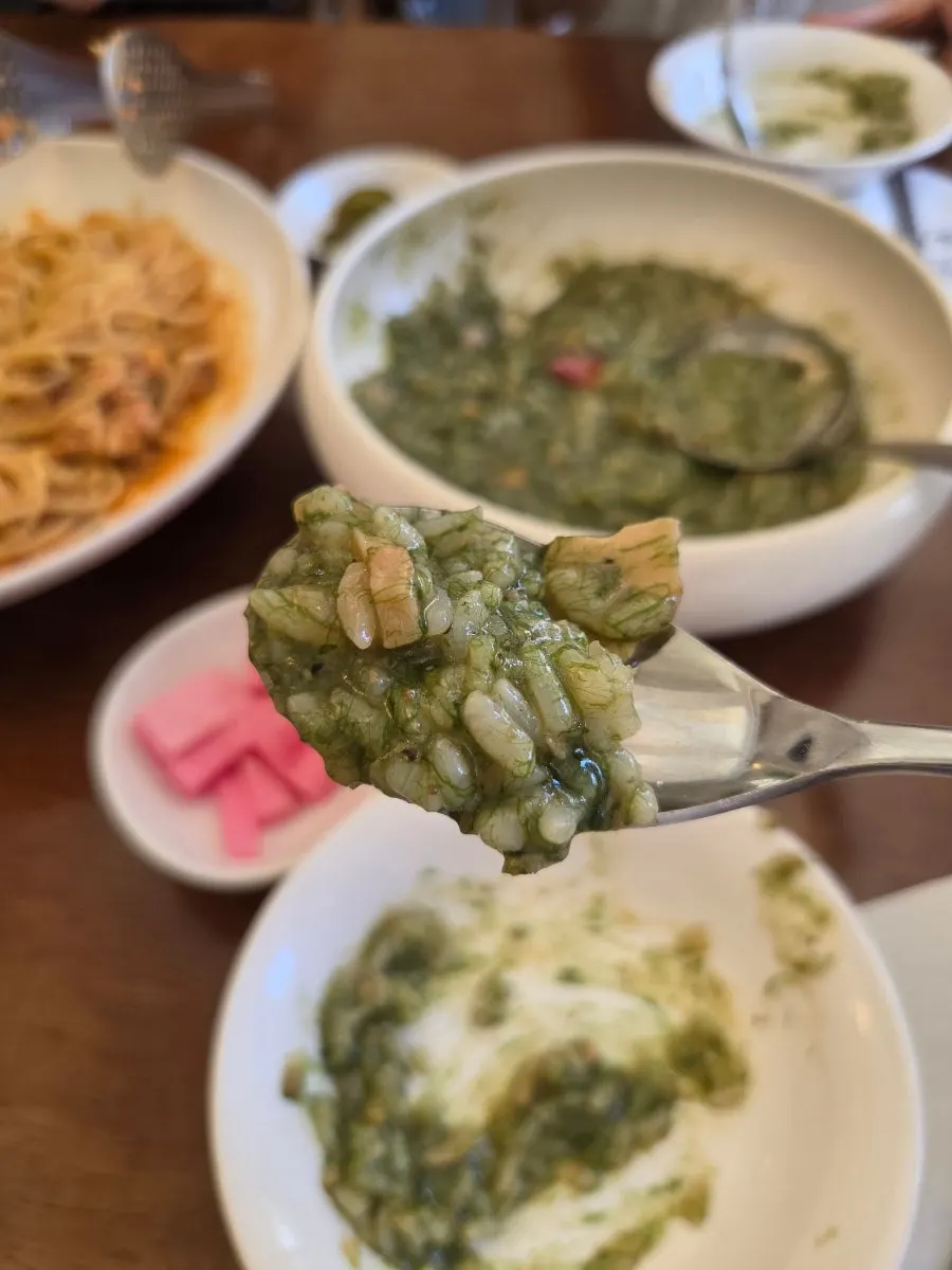 Close-up of gulfweed risotto with conch pieces