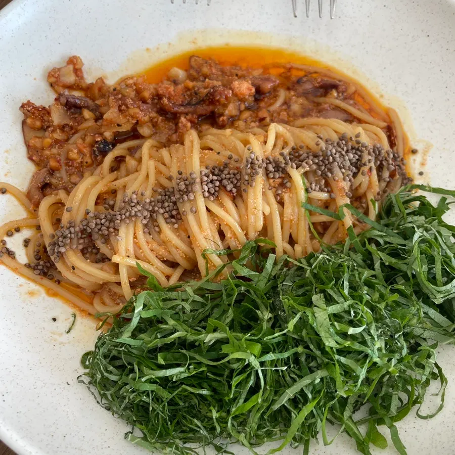 Fork lifting a bite of the perilla oil pasta