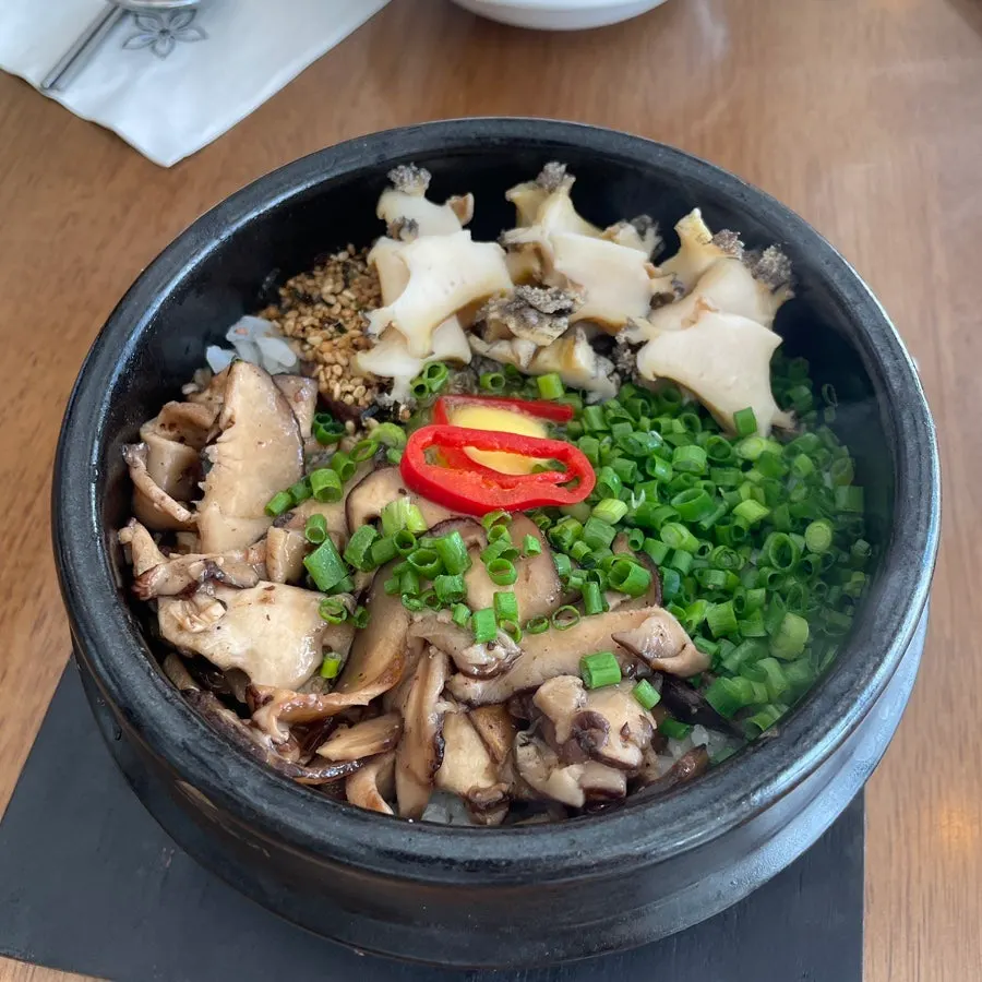 A spoonful of the mixed abalone-mushroom butter pot rice