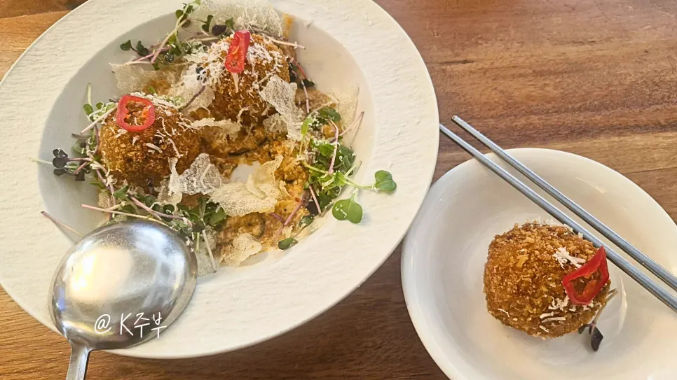 Bulgogi arancini placed over doenjang sauce