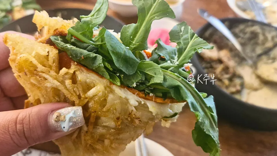 Potato pancake topped with arugula and cheese