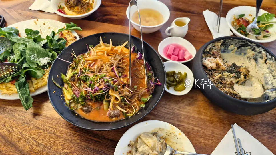 The full spread of four fusion Korean dishes shared by three friends