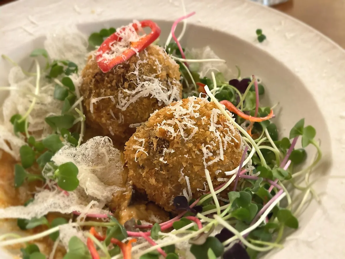 Cross-section of barley doenjang arancini cut open with a fork