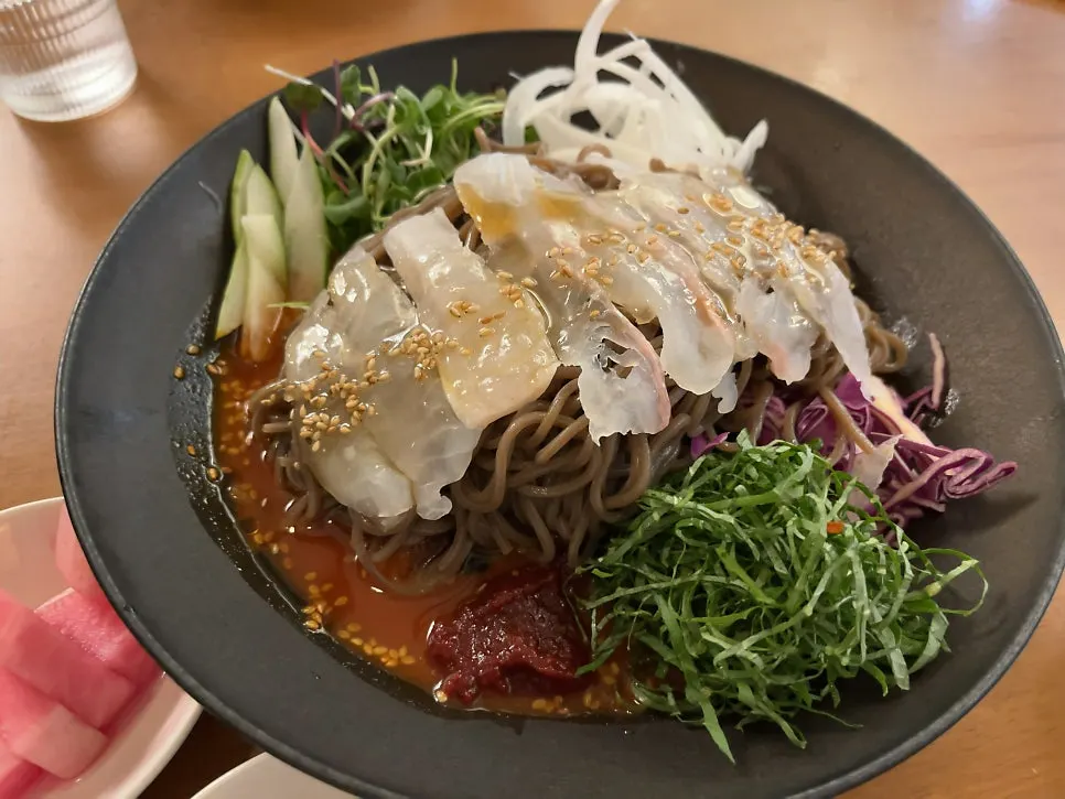 Flounder mixed into spicy sauce over buckwheat noodles