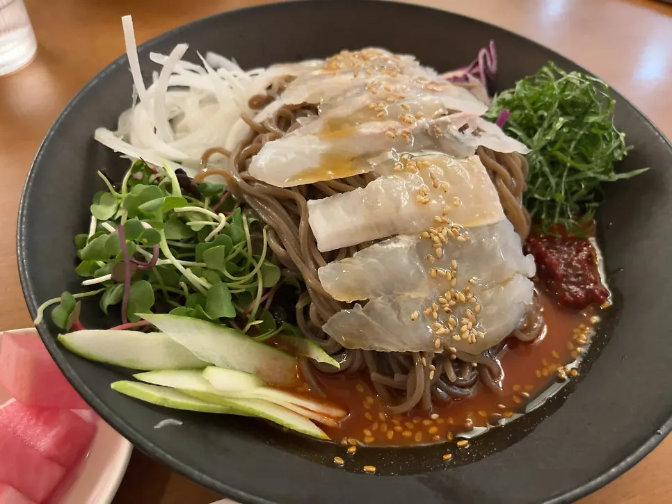 Chewy buckwheat noodles lifted with chopsticks