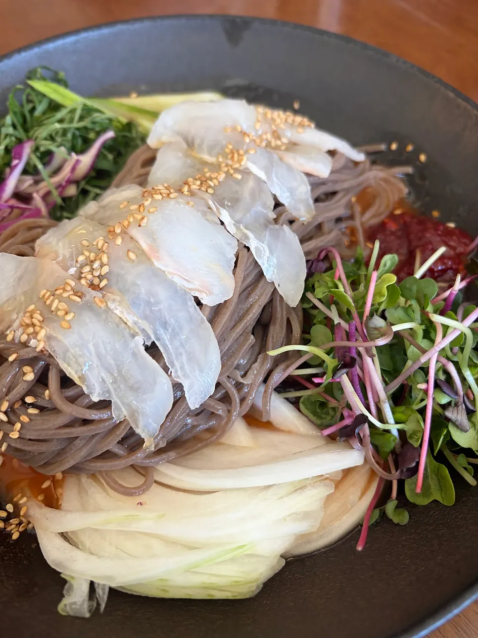 Spicy buckwheat noodles topped with flounder and vegetables