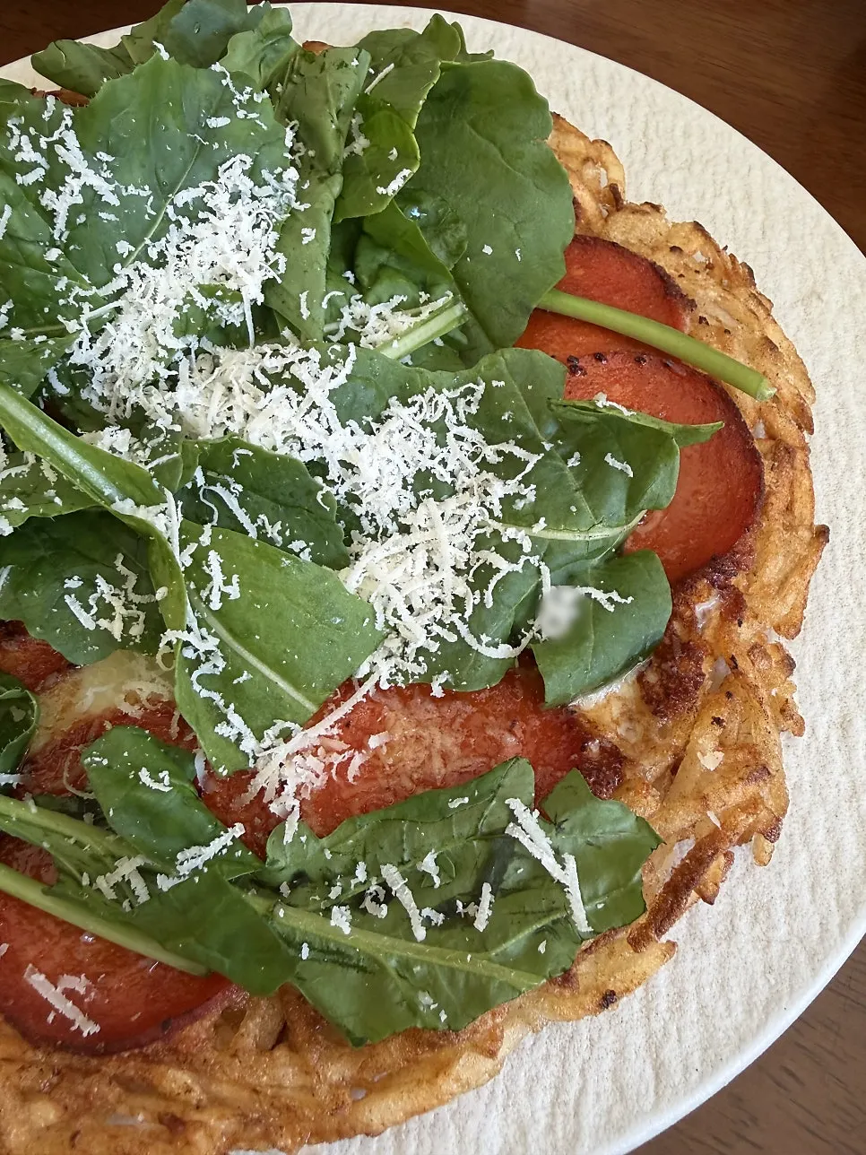 A bite of arugula cheese potato pancake with honey