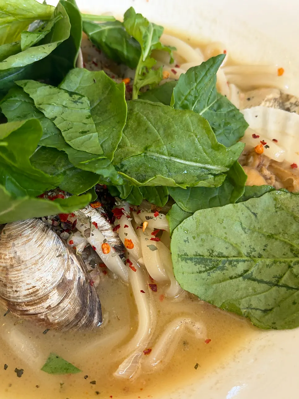 Lifting kalguksu noodles from the vongole broth