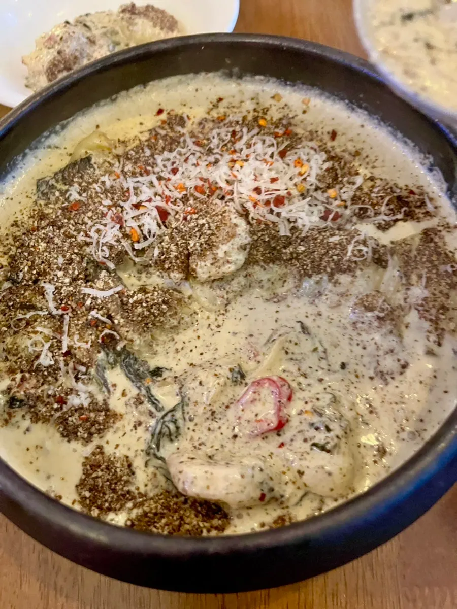 Sujebi in bluish gondre cream sauce