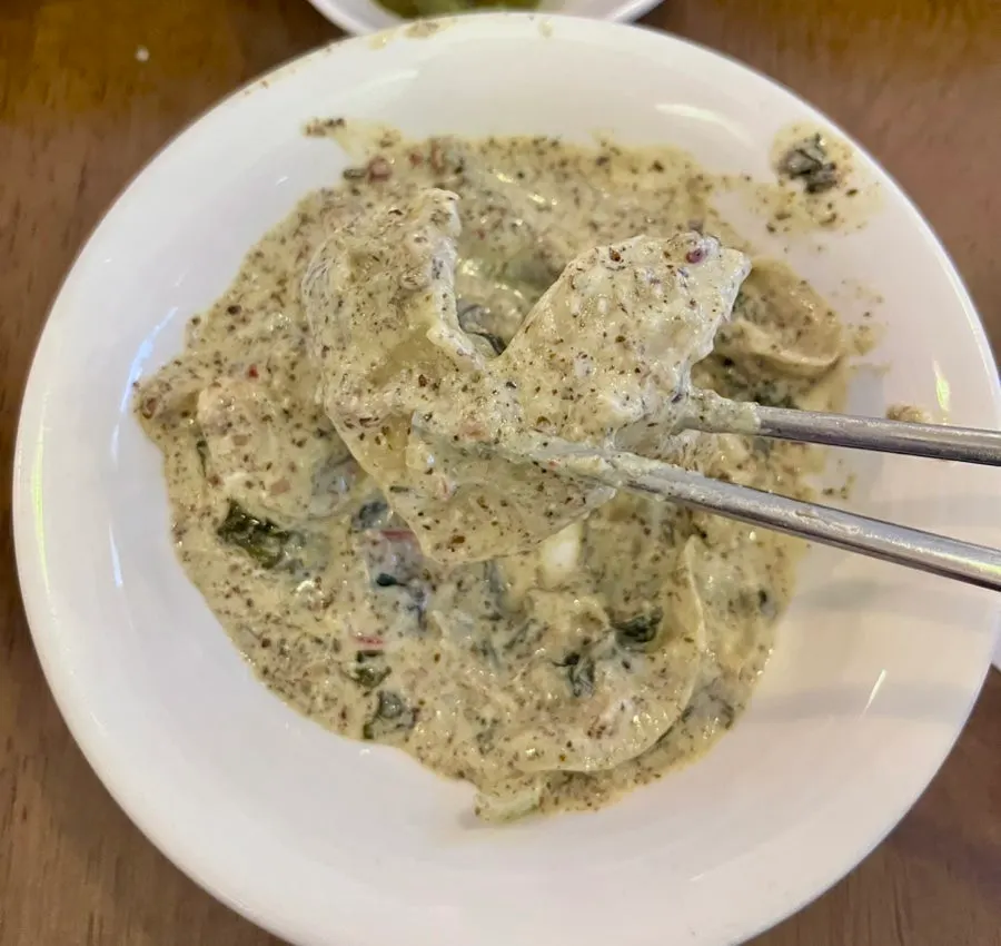 Close-up of sujebi soaked in cream sauce