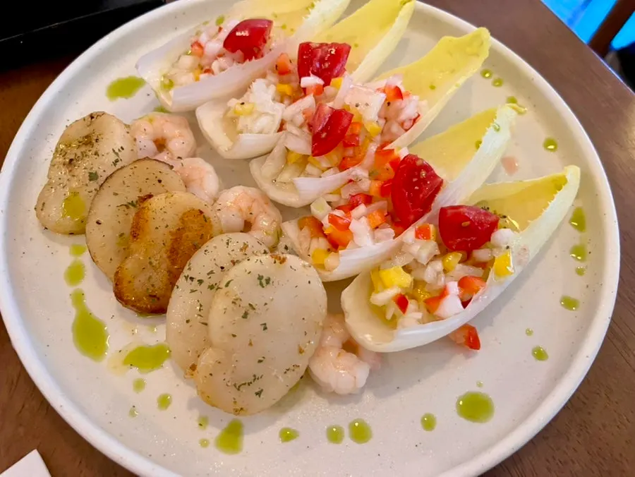 Table setting with grilled scallop and endive bites