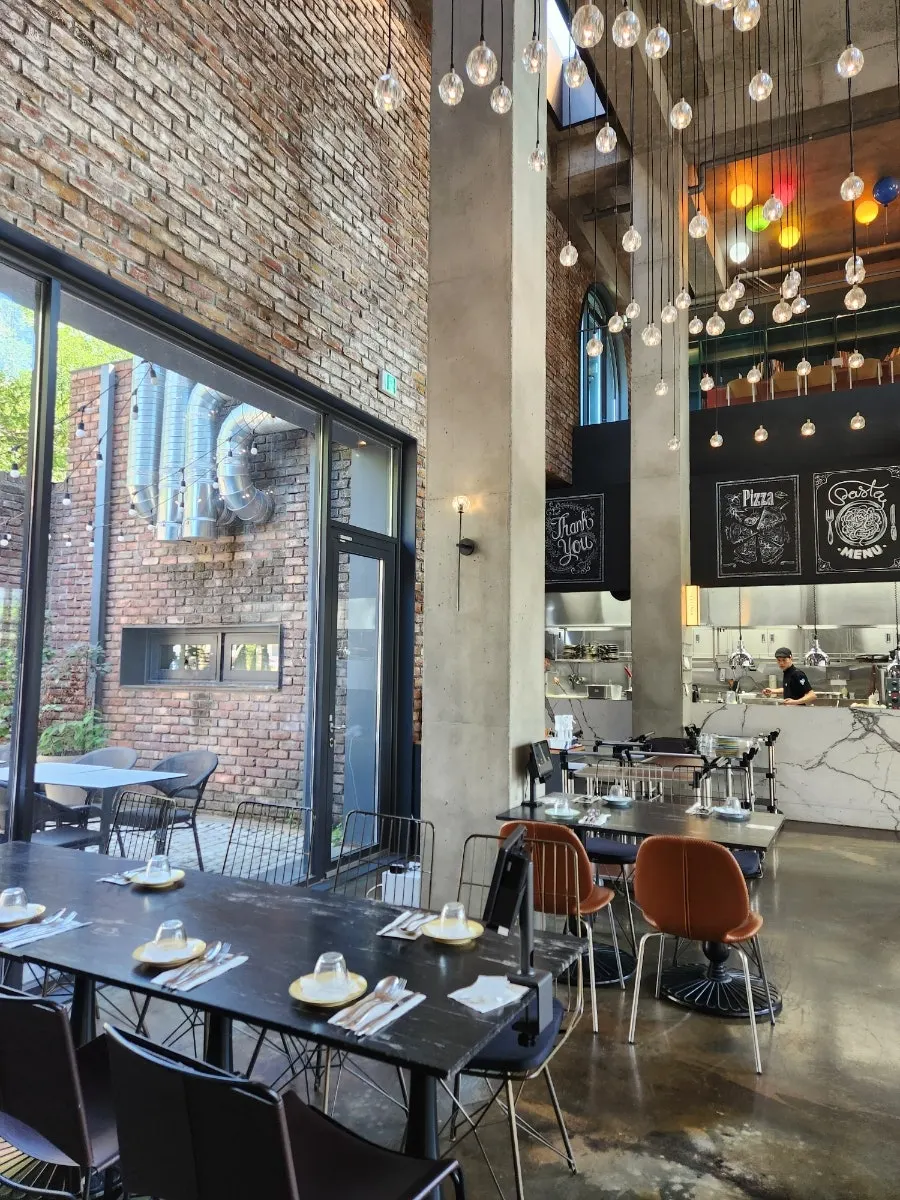 Seating at Mokushura Table lit by floor-to-ceiling windows