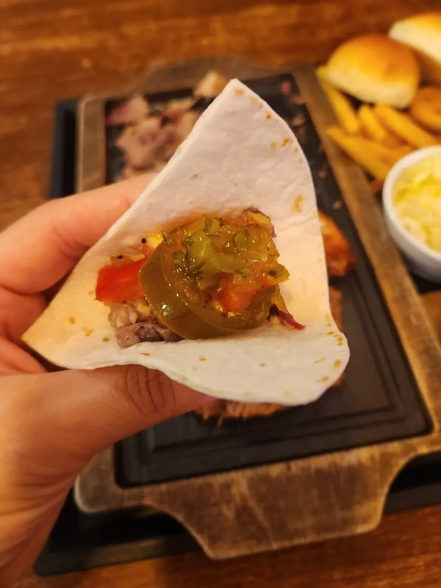 Pulled pork piled onto a tortilla
