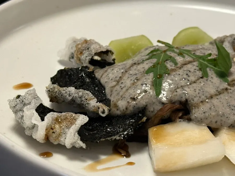 Plate of grilled vegetables with black sesame dressing and laver crisps