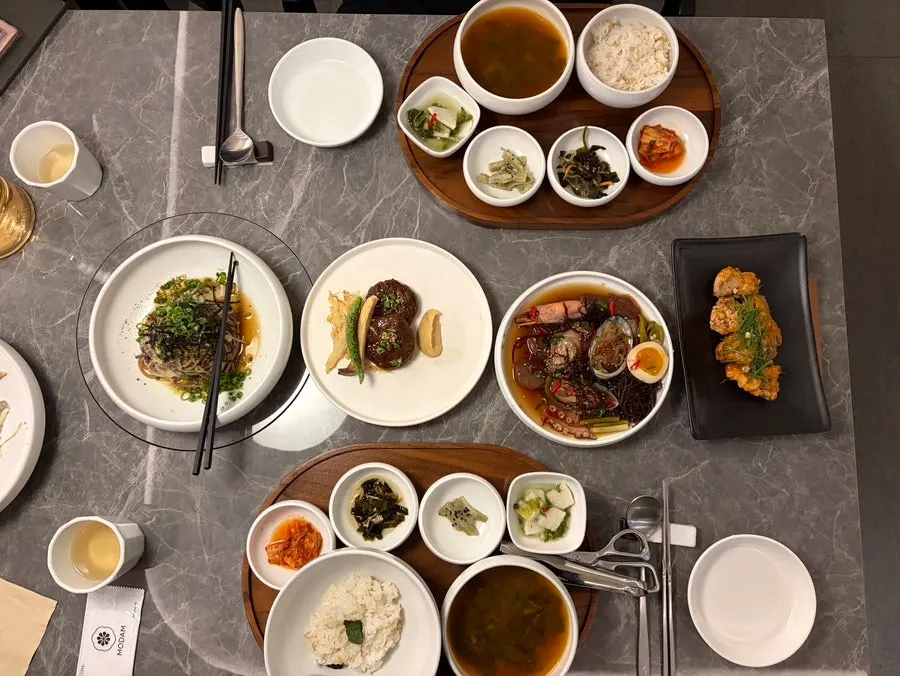 Handmade tteokgalbi served with deodeok and vegetables