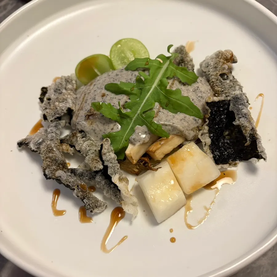 Black sesame salad topped with eggplant, mushroom, and gim bugak