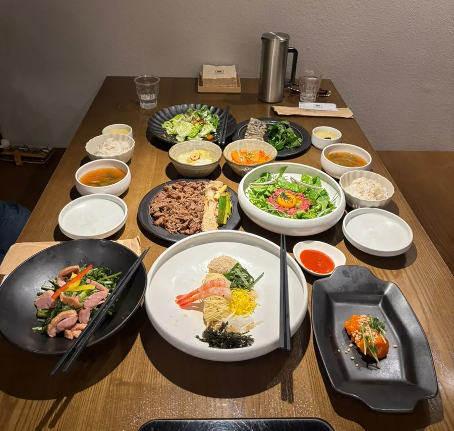 Minari hanwoo yukhoe bibimbap and crispy bulgogi table spread