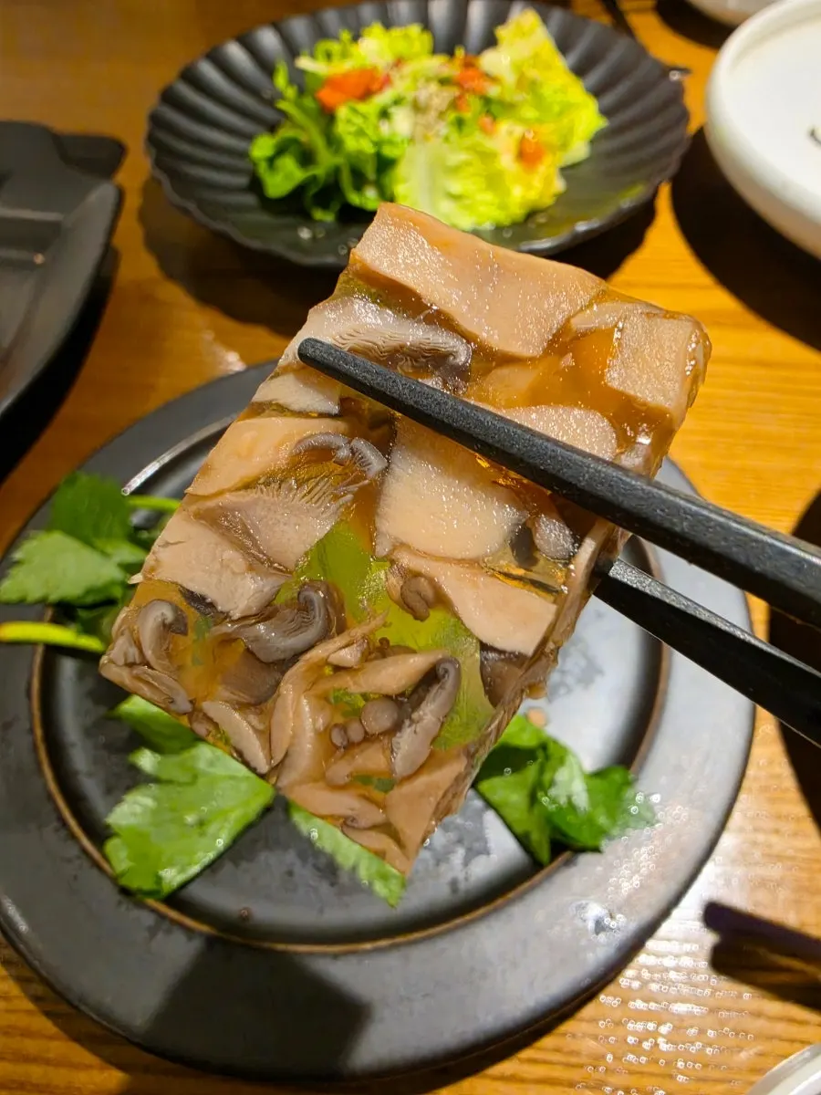 A bowl of soft mung bean porridge topped with black sesame
