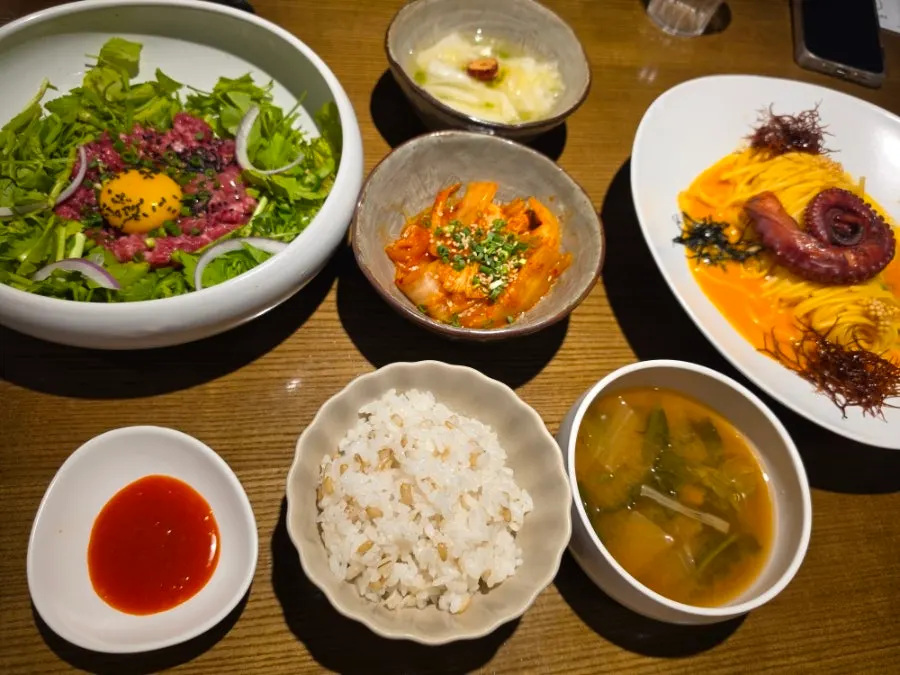 Main course spread of octopus pasta and yukhoe bibimbap