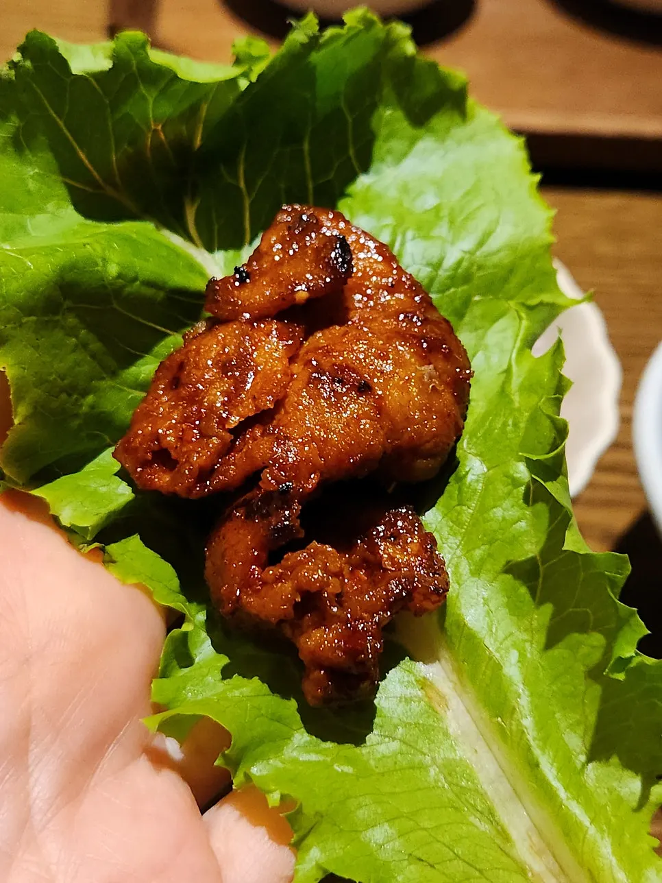 Charcoal-grilled pork wrapped in lettuce leaf