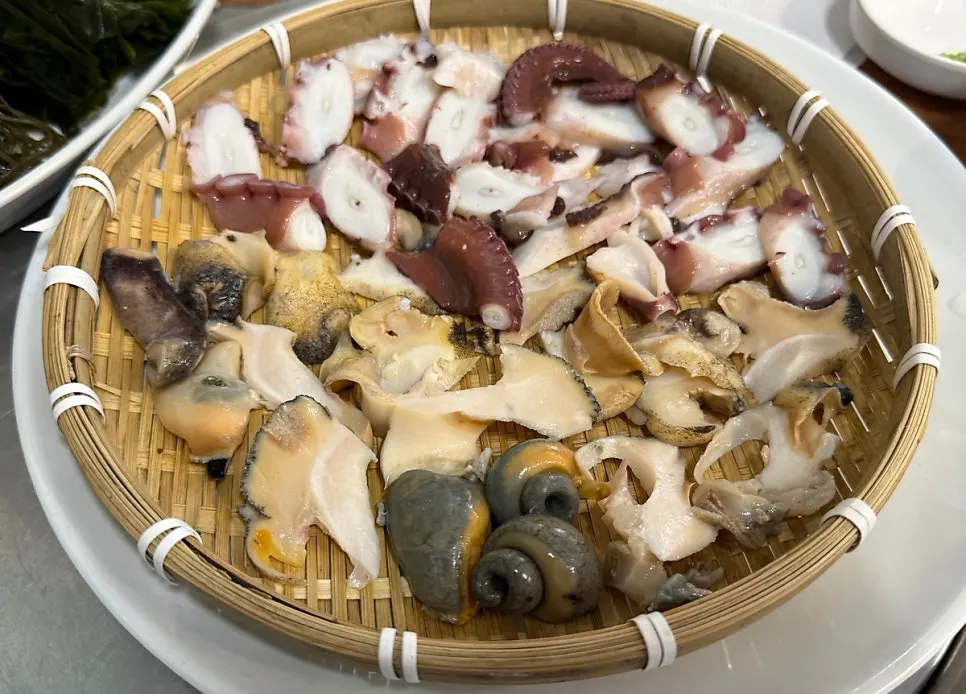 Whelk, octopus and ganjang gejang served on one plate