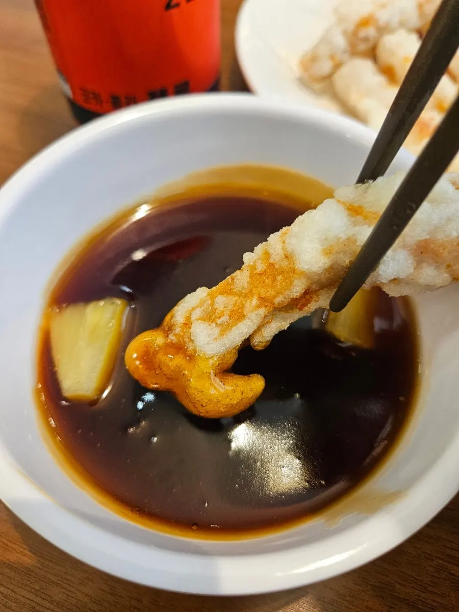 Cross-section of tangsuyuk dipped in sauce