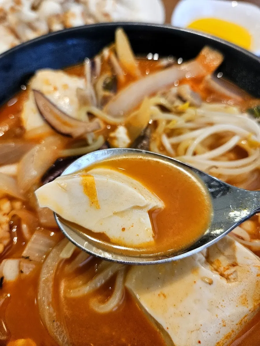 Chopsticks picking up a piece of tangsuyuk