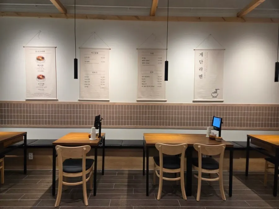 Menu board and waitlist sheet at the entrance