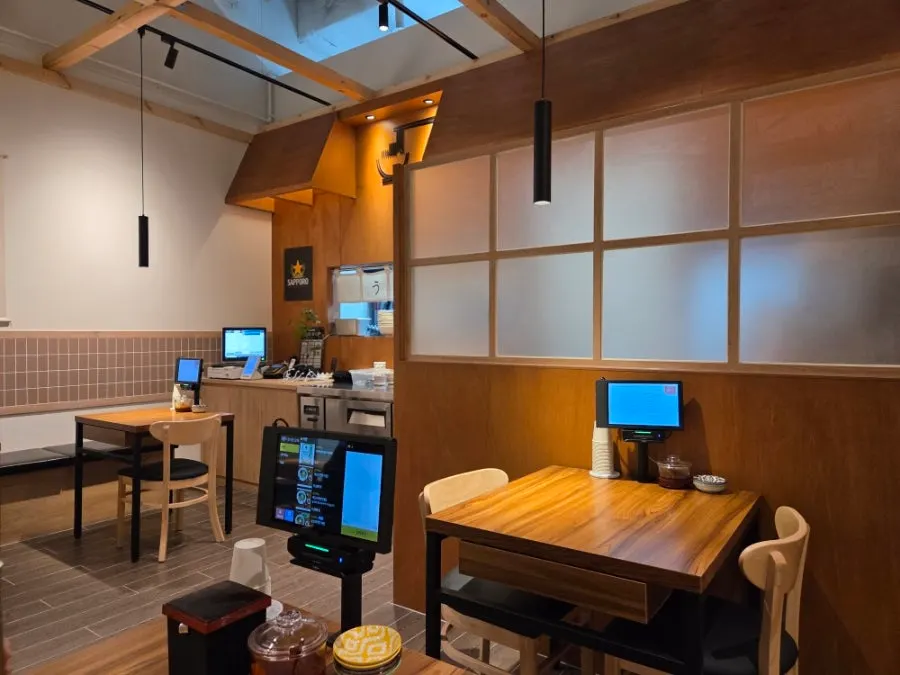 Interior with hanging scroll menu on the wall, ramen shop atmosphere