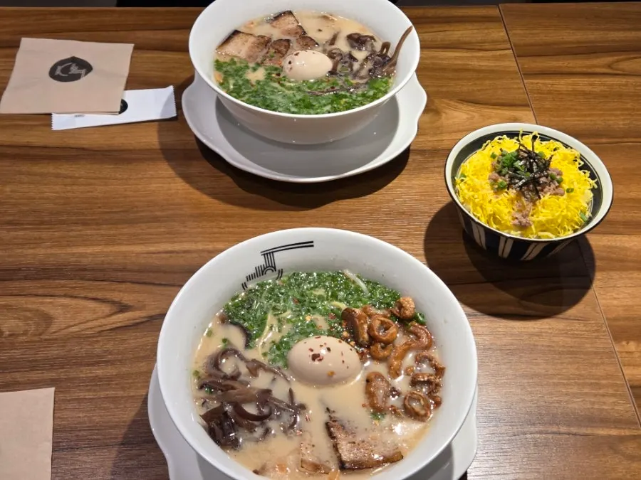Two bowls of ramen and tamago bap served in ceramic bowls