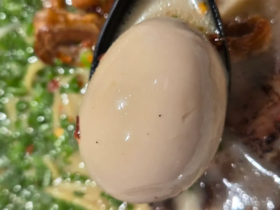 Close-up of Motsu Ramen piled with fried pork intestines