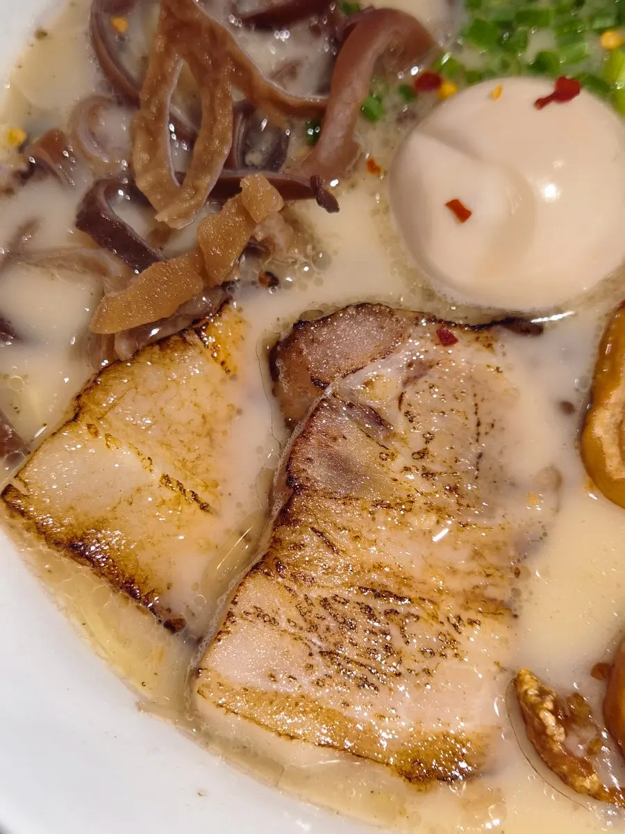 Noodles lifted up from the Motsu Ramen bowl