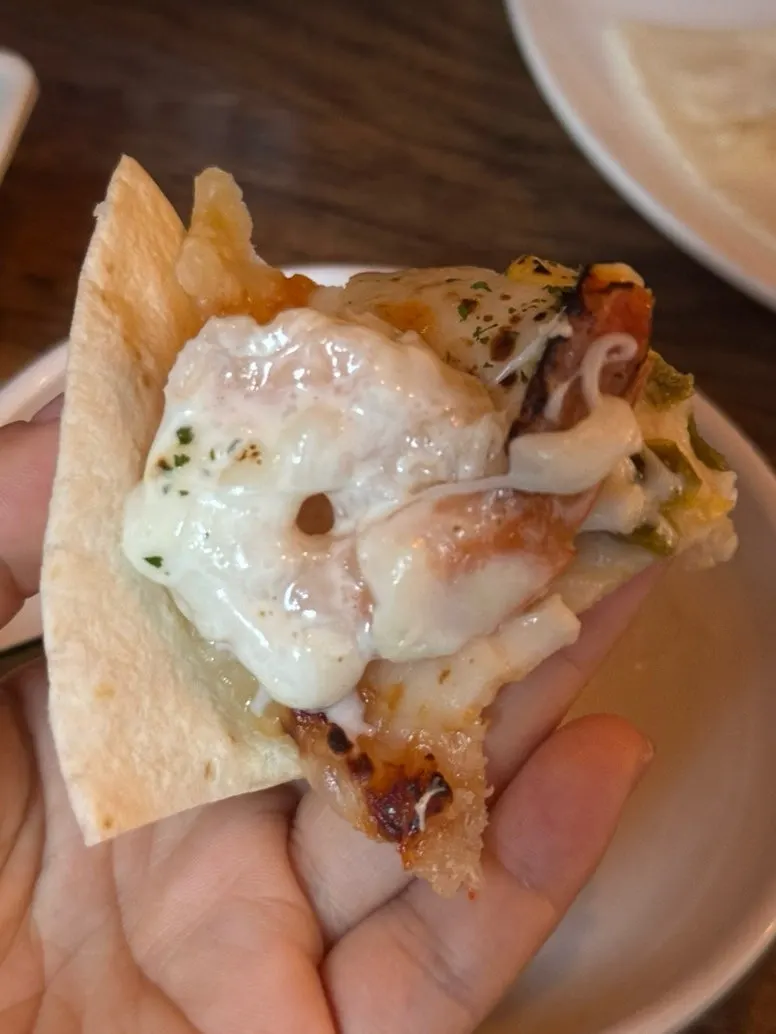 A piece of shrimp dipped in cheese