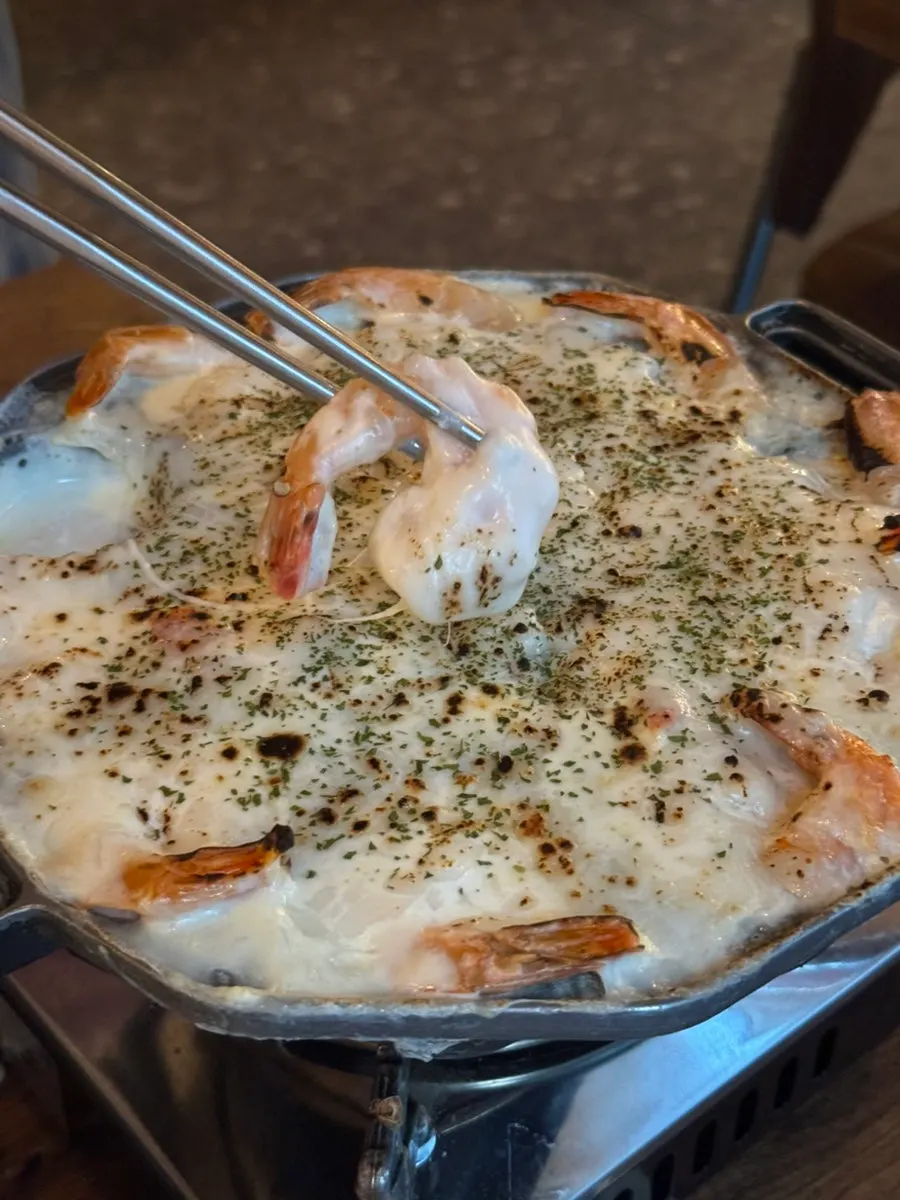 Dinner roll dipped in cheese fondue