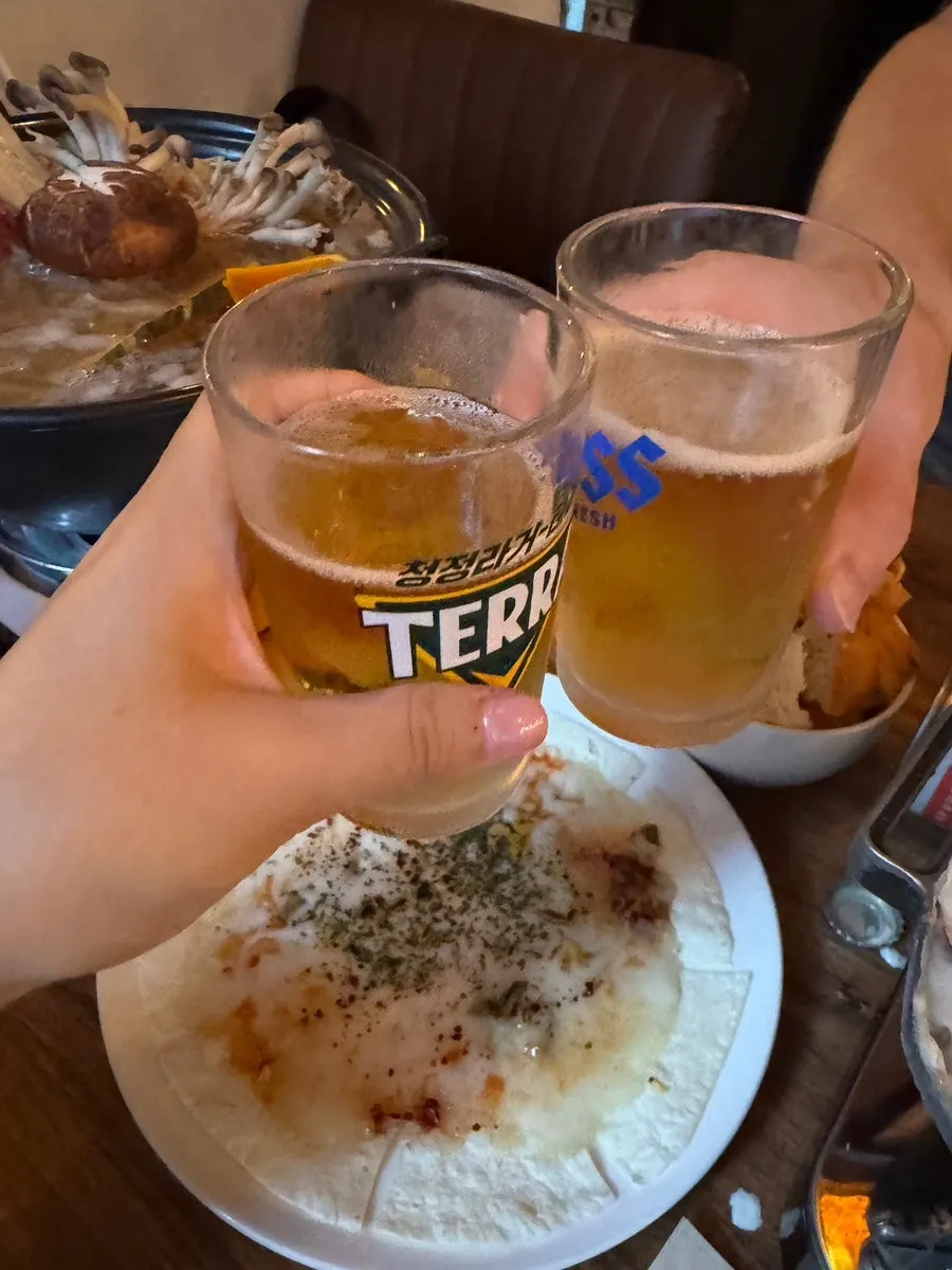 A glass of beer next to the anju