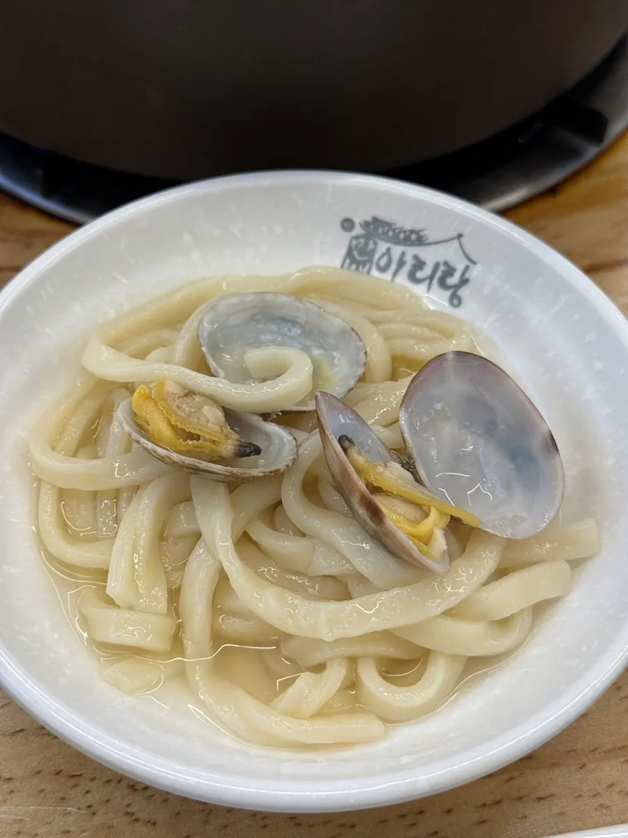 Complimentary kalguksu with blue crab and clams