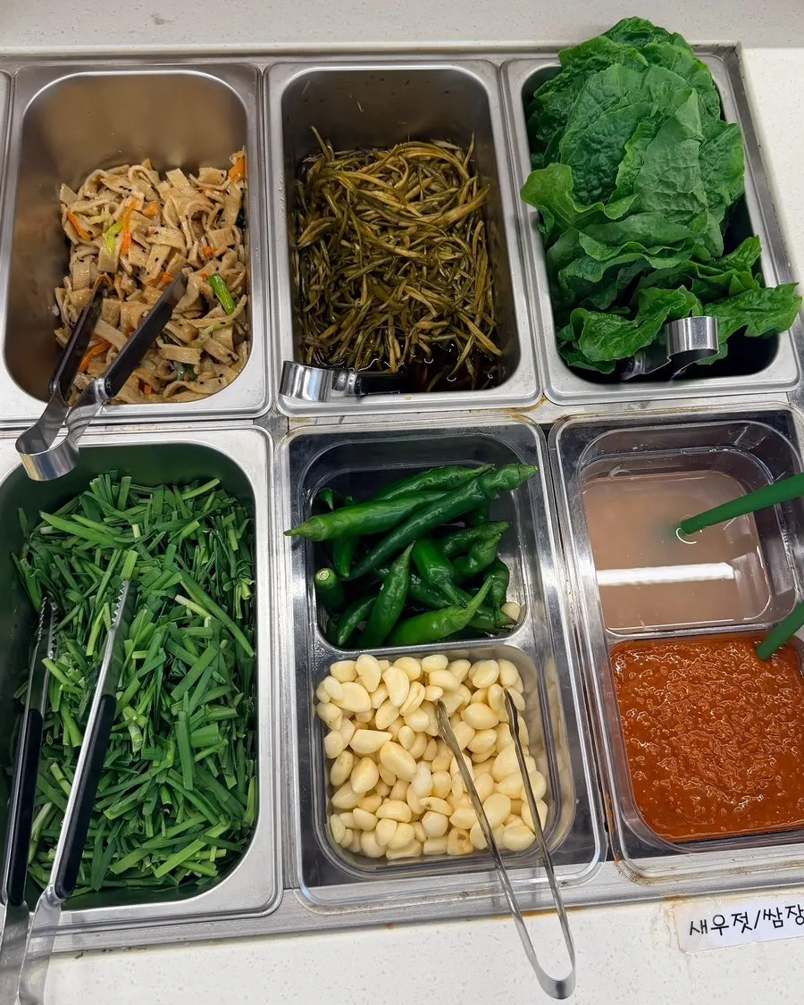 Container of pickled garlic scapes at the self-bar
