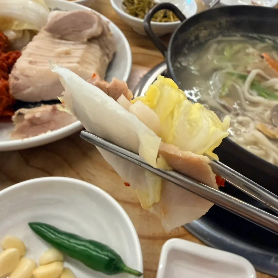 Full table spread of bossam with various side dishes