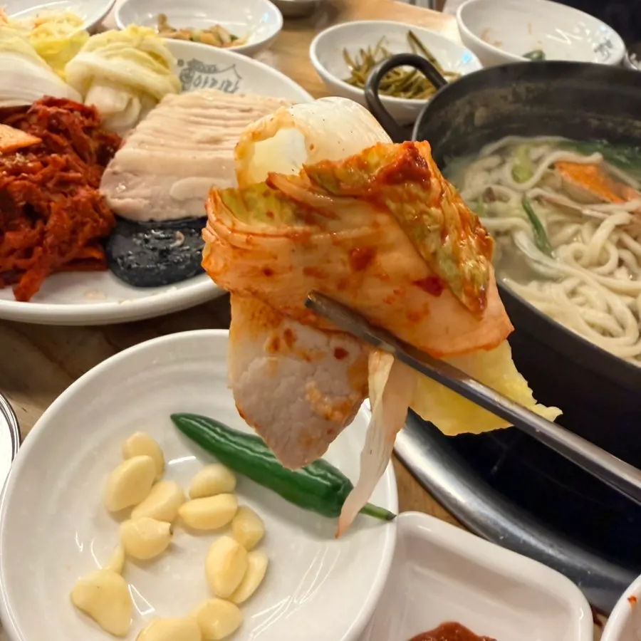Table with bossam and a bowl of rice