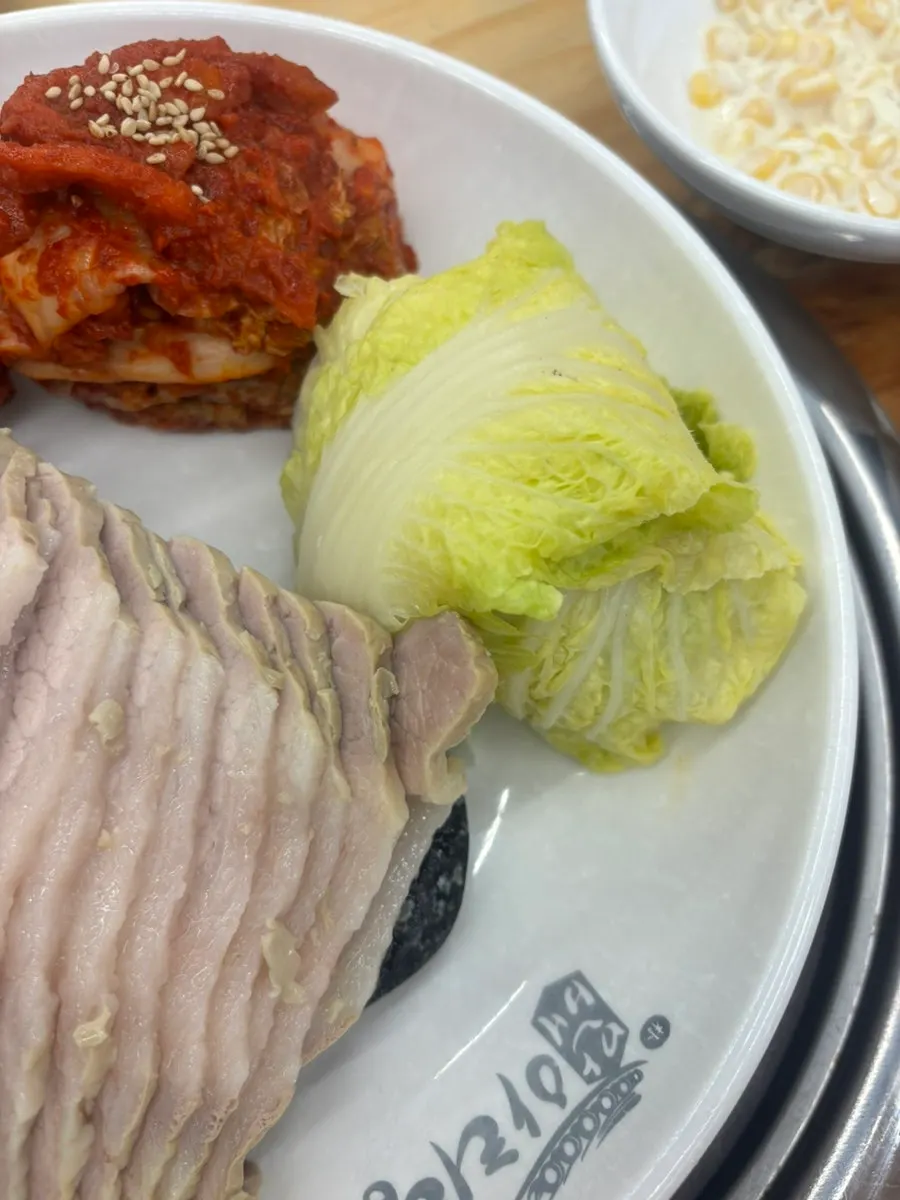 Plates of bossam kimchi and pickled cabbage