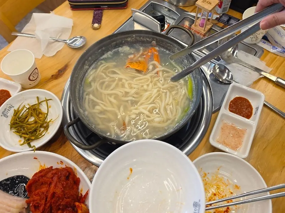 Kalguksu noodles simmering at the table