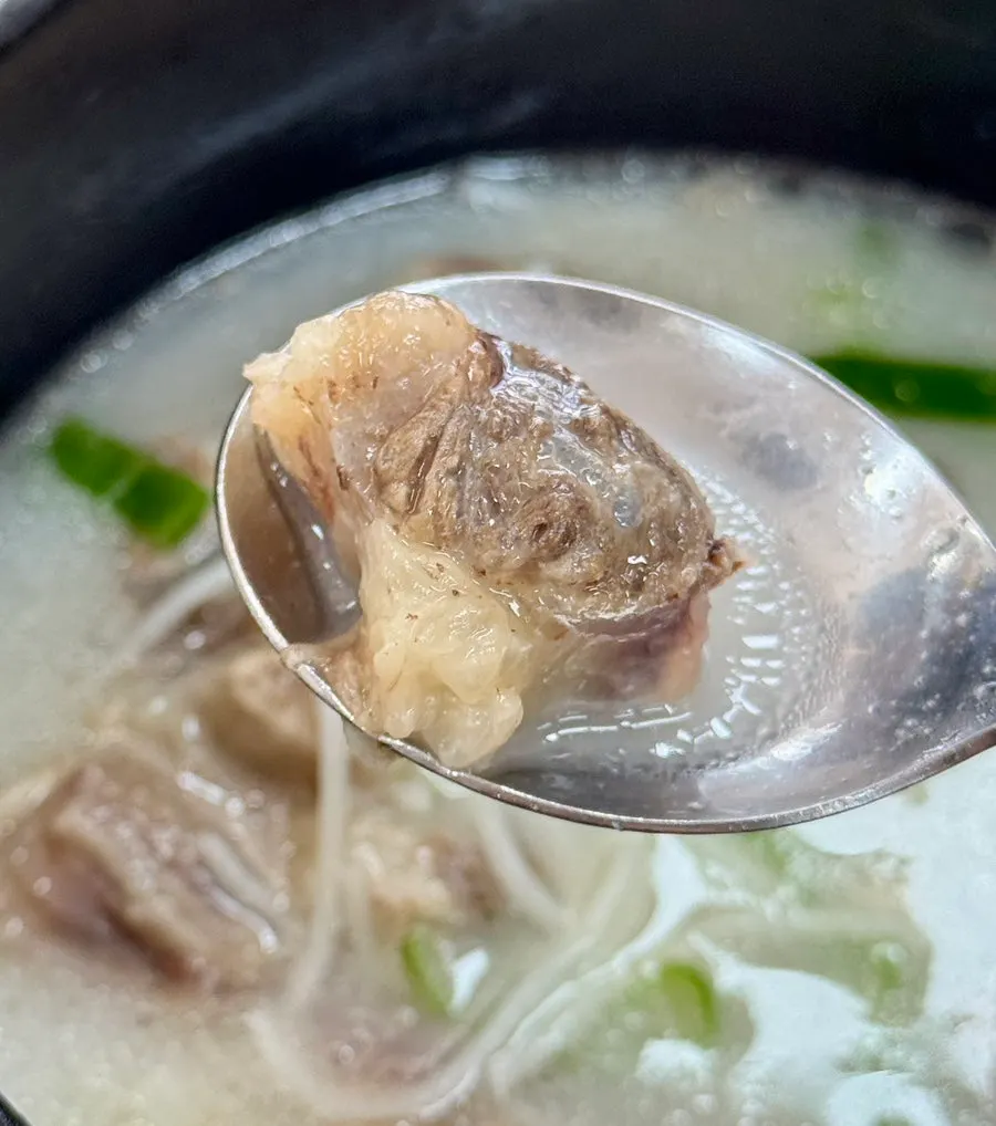 A spoonful of the mild gomtang broth