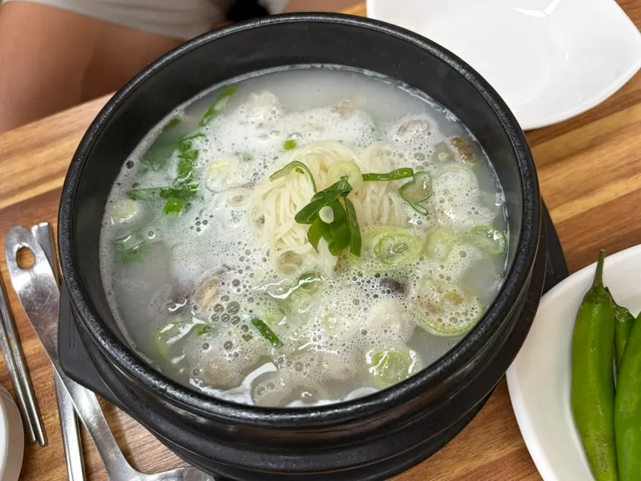 Beef tail soup served bubbling in a stone bowl