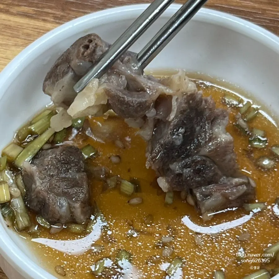 Soup bowl with oxtail meat picked off, and dipping sauce
