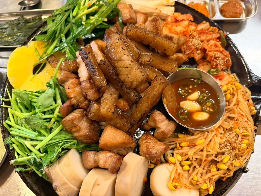 Meat platter topped with side dishes