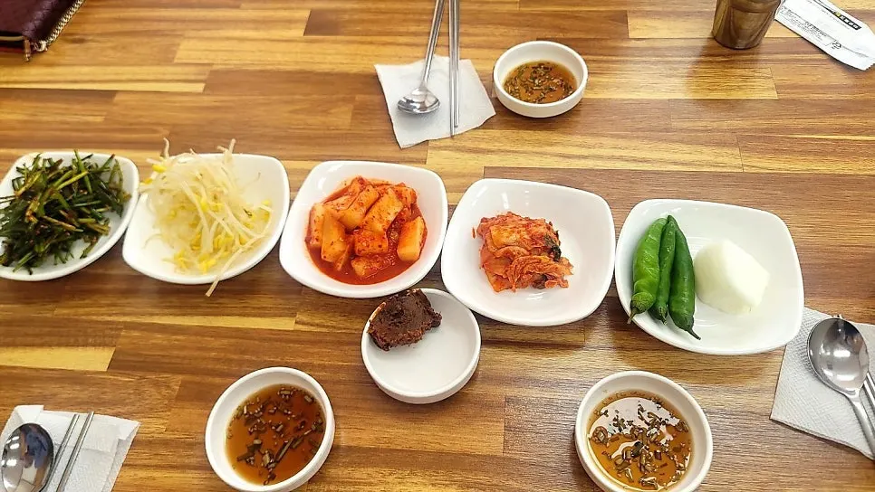 Full spread of side dishes for beef tail soup