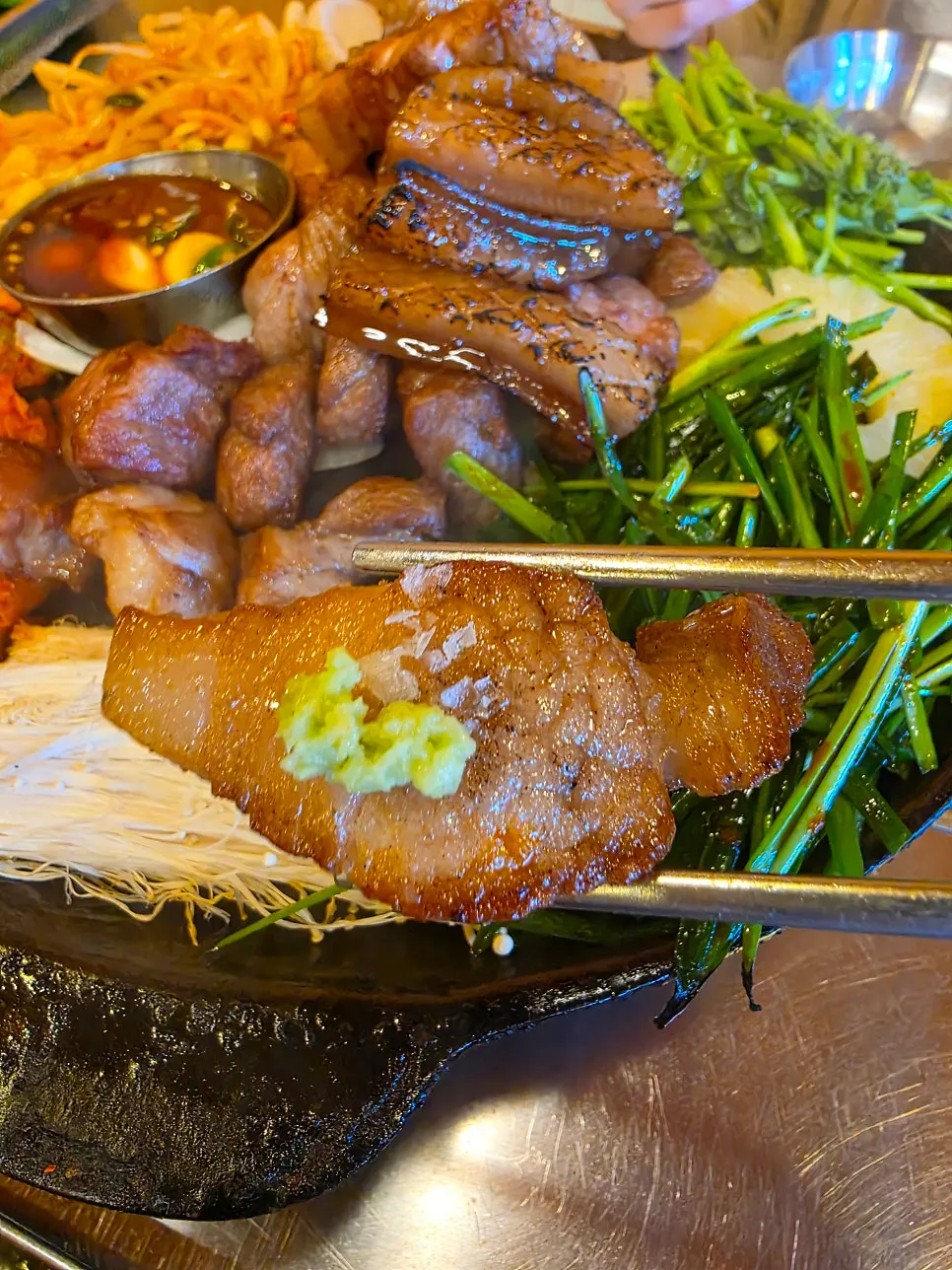 Piece of duroc pork belly dipped in sauce