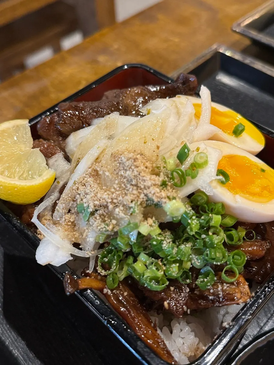 A bite of charcoal-grilled pork rib over rice